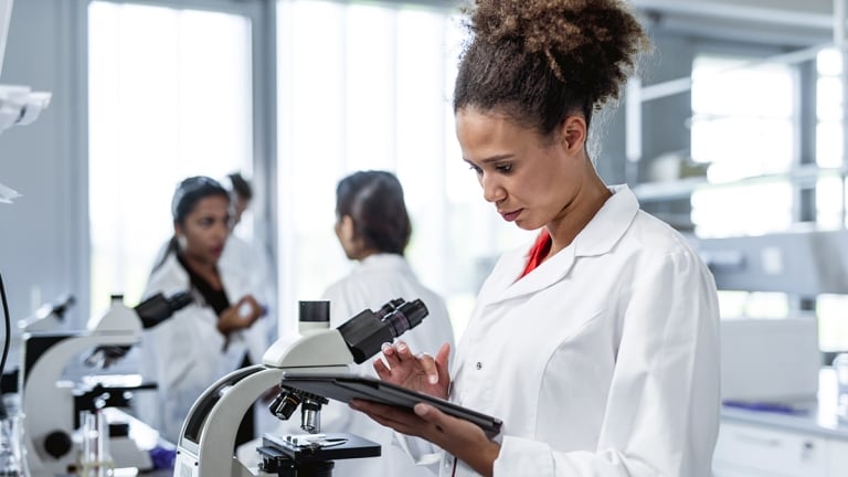 Young African American woman using a digital tablet in the laboratory 