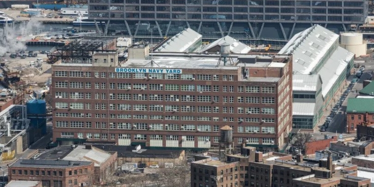 Aerial shot of building with sign that says Brooklyn Navy Yard